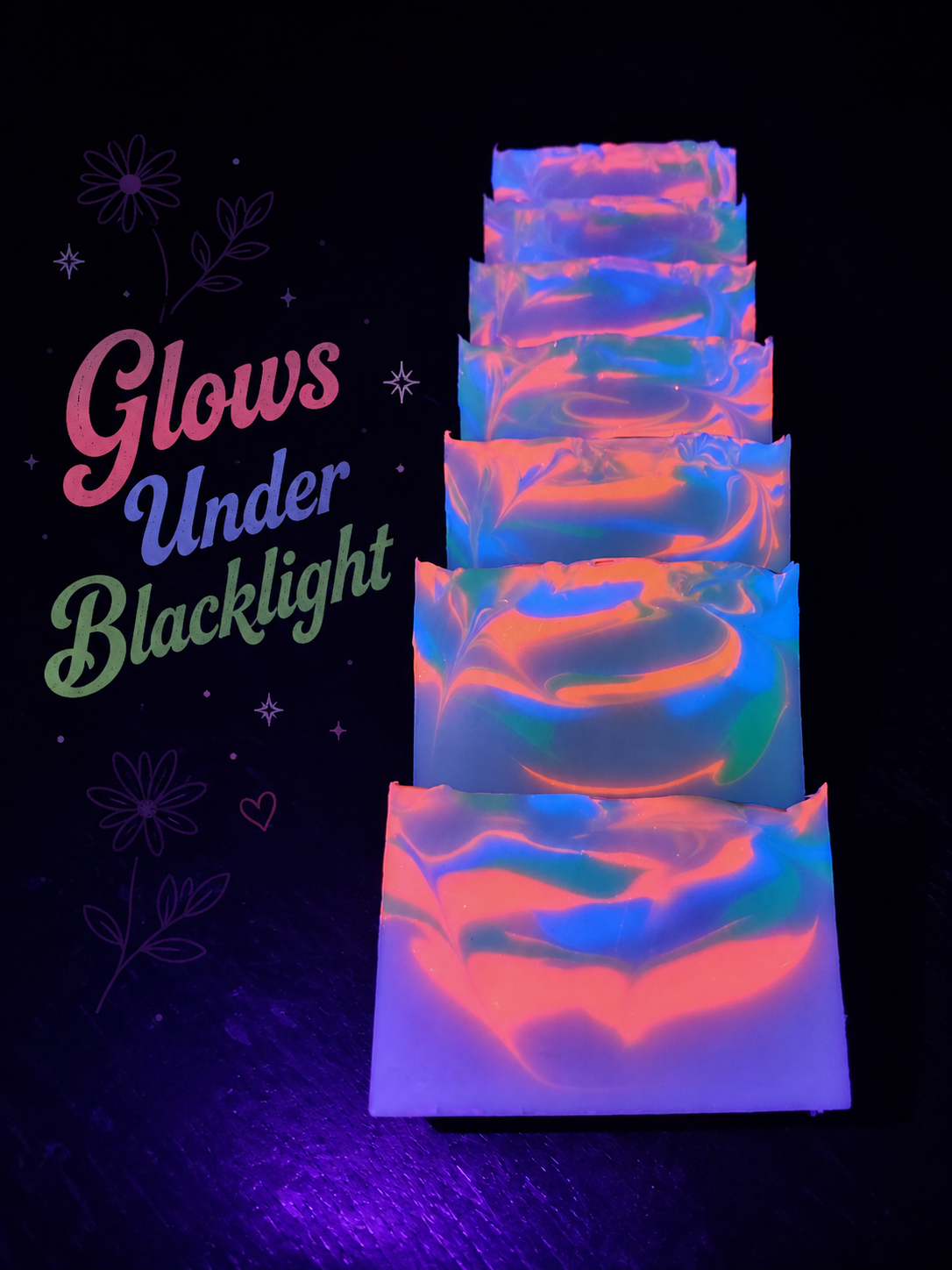Stacked handmade soap bars glowing under blacklight with neon swirls of pink, blue, and green beside text 'Glows Under Blacklight'